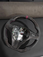 Romeo and Juliet carbon fiber steering wheel paired with purple return-to-center emblem, wrapped in perforated black leather