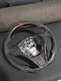 Romeo and Juliet carbon fiber steering wheel paired with purple return-to-center emblem, wrapped in perforated black leather