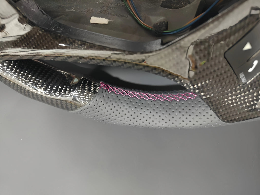 Romeo and Juliet carbon fiber steering wheel paired with purple return-to-center emblem, wrapped in perforated black leather