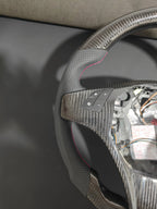 Romeo and Juliet carbon fiber steering wheel paired with purple return-to-center emblem, wrapped in perforated black leather