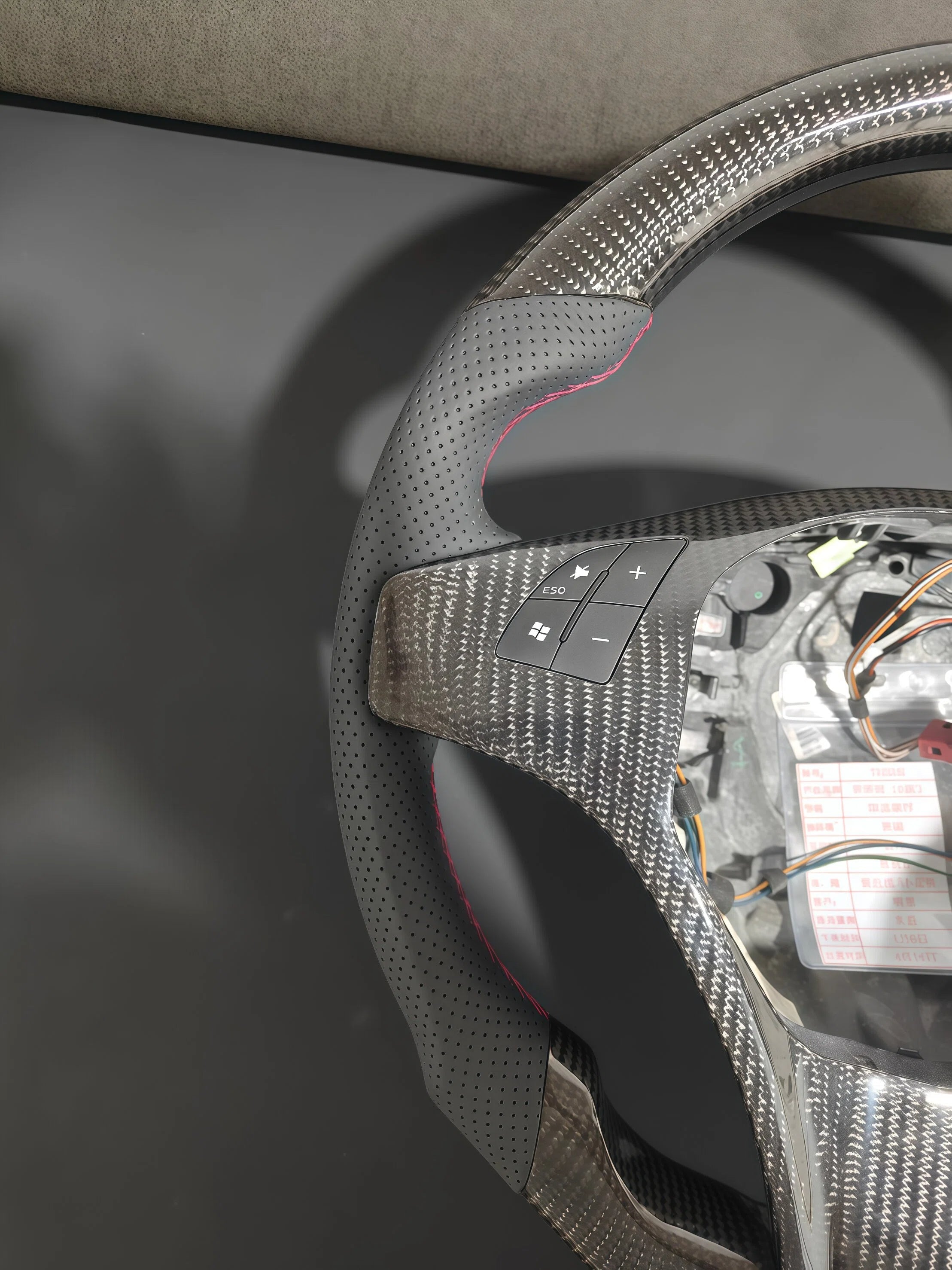 Romeo and Juliet carbon fiber steering wheel paired with purple return-to-center emblem, wrapped in perforated black leather