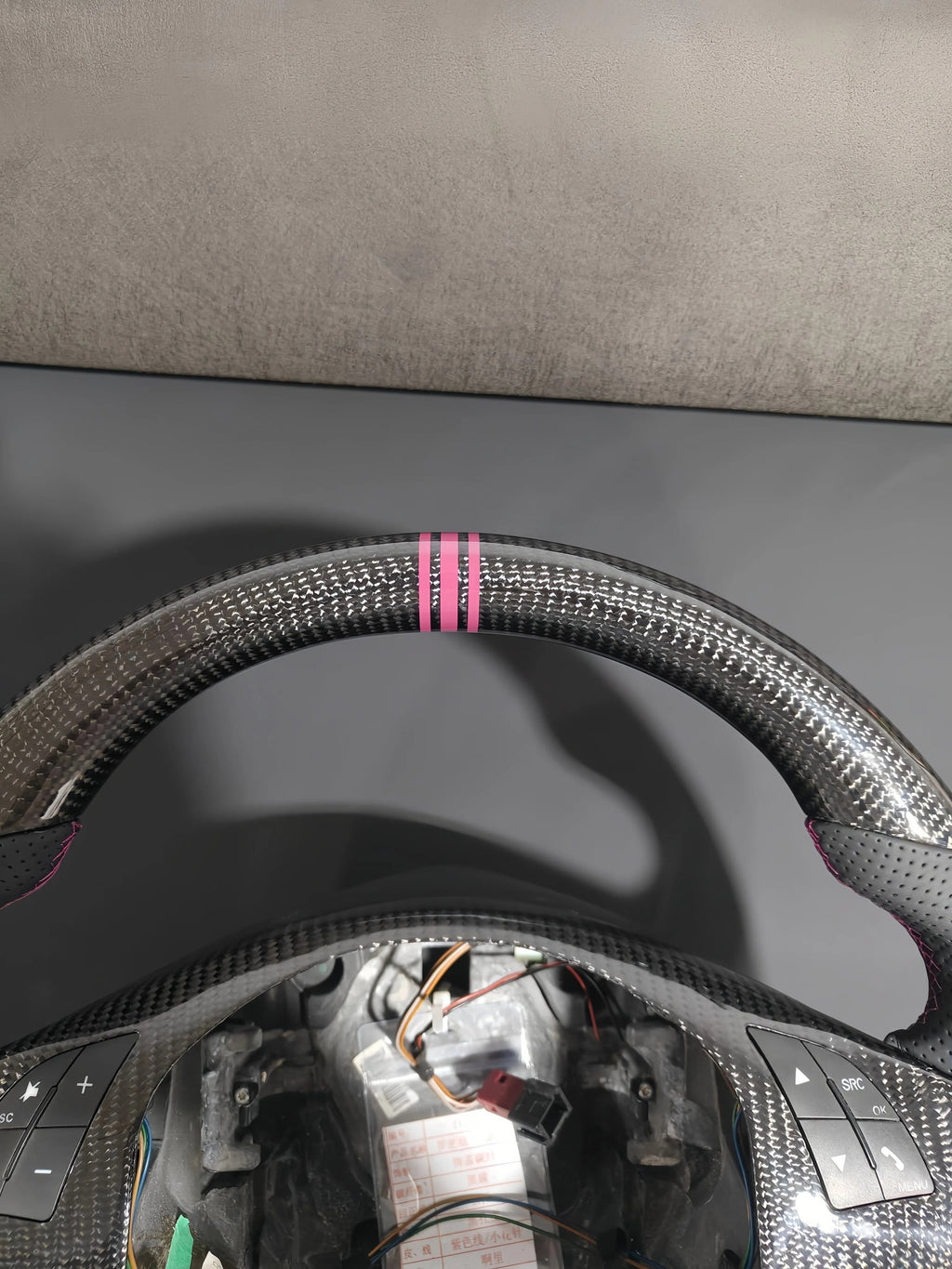 Romeo and Juliet carbon fiber steering wheel paired with purple return-to-center emblem, wrapped in perforated black leather