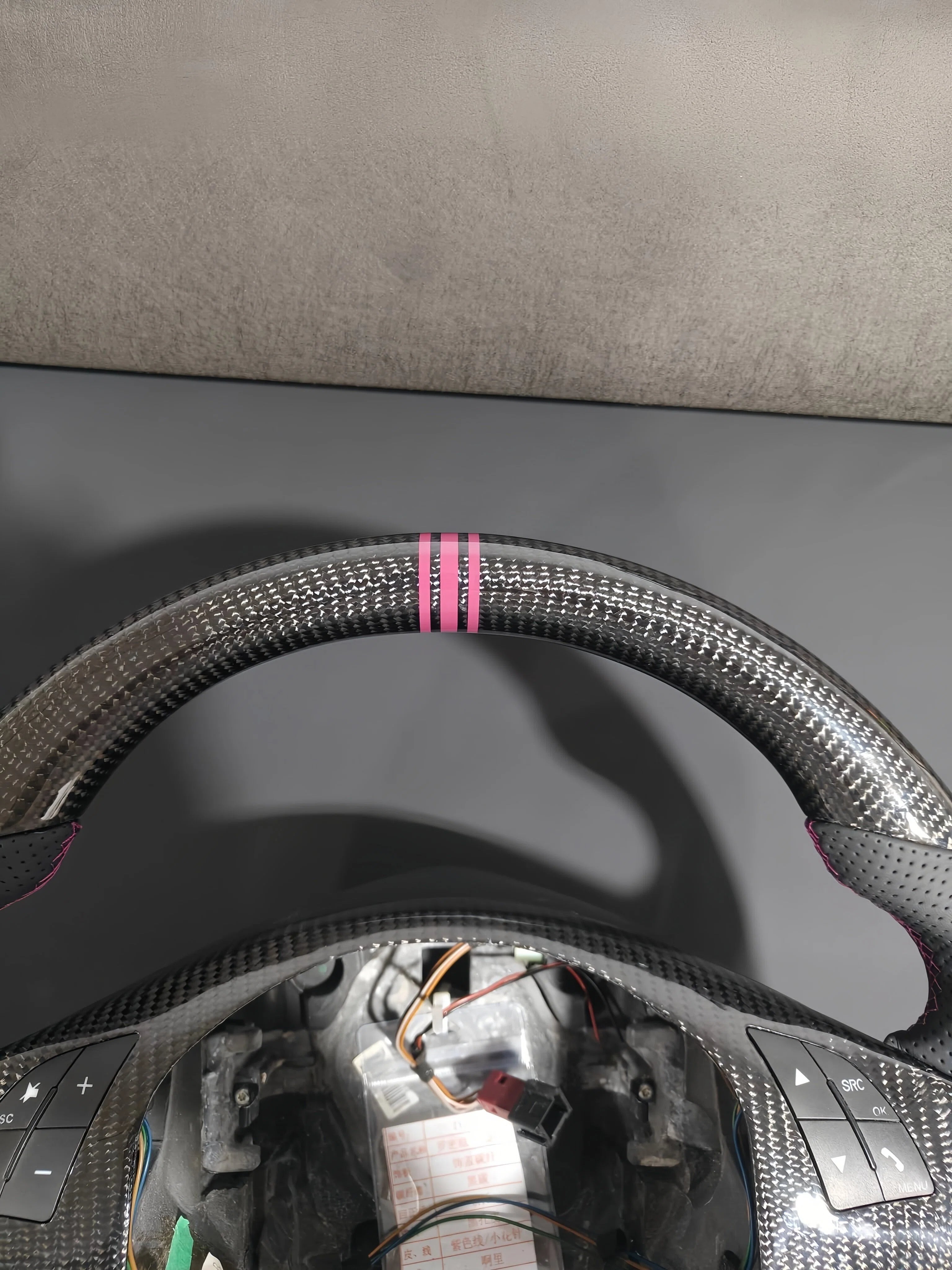Romeo and Juliet carbon fiber steering wheel paired with purple return-to-center emblem, wrapped in perforated black leather