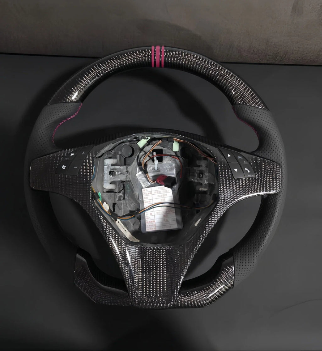 Romeo and Juliet carbon fiber steering wheel paired with purple return-to-center emblem, wrapped in perforated black leather