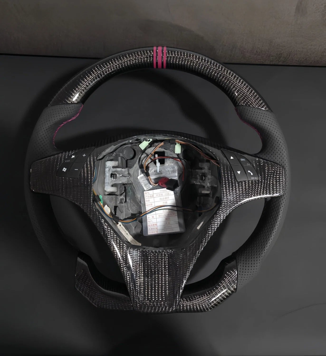 Romeo and Juliet carbon fiber steering wheel paired with purple return-to-center emblem, wrapped in perforated black leather